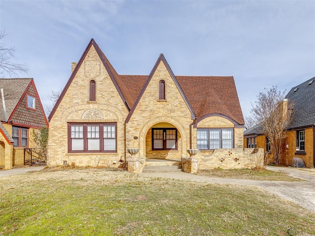 tudor house with a front yard