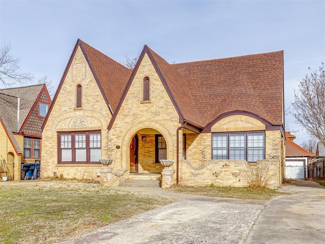 tudor house featuring a front lawn