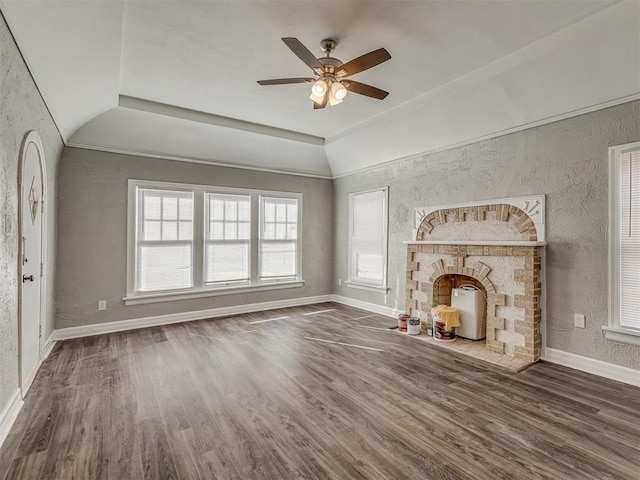 unfurnished living room with lofted ceiling, dark hardwood / wood-style floors, and ceiling fan