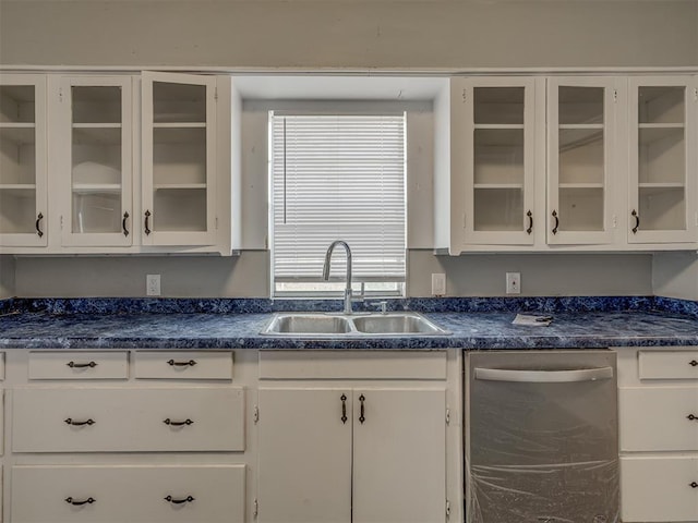 kitchen with plenty of natural light, sink, stainless steel dishwasher, and white cabinets