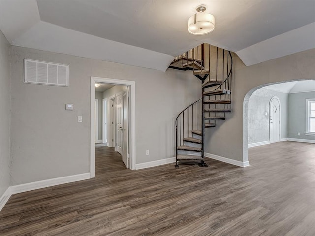 interior space featuring dark hardwood / wood-style floors and vaulted ceiling