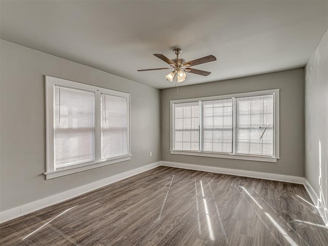 unfurnished room with dark hardwood / wood-style flooring and ceiling fan