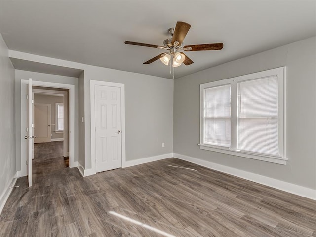 unfurnished room featuring dark hardwood / wood-style floors and ceiling fan