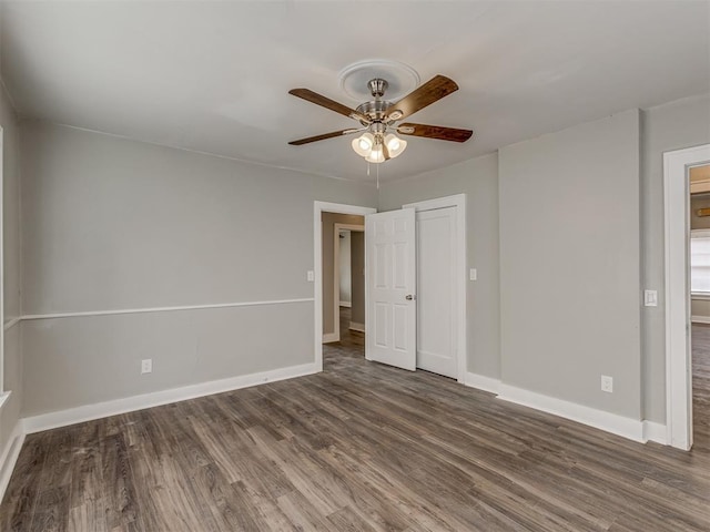 unfurnished room featuring dark hardwood / wood-style floors and ceiling fan