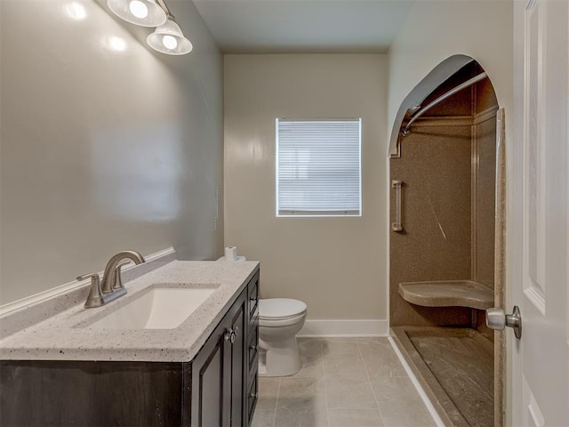 bathroom with vanity, toilet, tile patterned flooring, and a shower