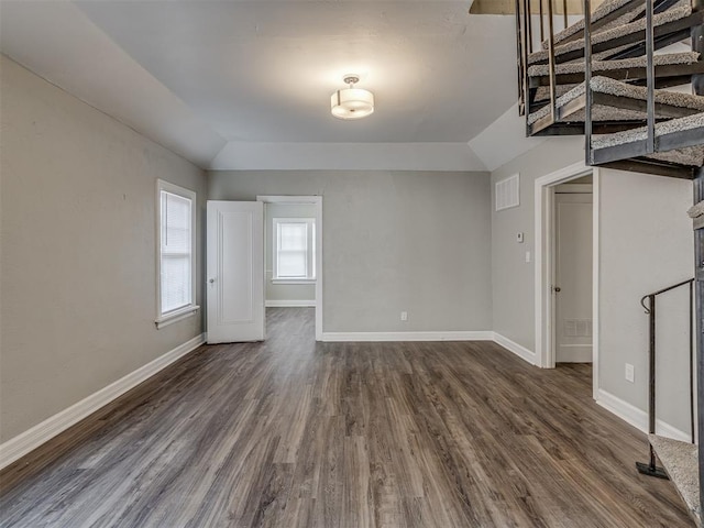 3105 NW 22nd St, Oklahoma City, OK 73107 - unfurnished living room with dark wood-style flooring, baseboards, and vaulted ceiling
