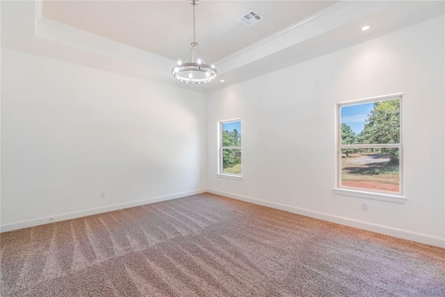 carpeted spare room with an inviting chandelier, crown molding, and a raised ceiling