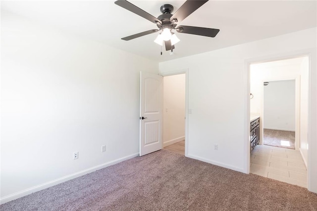 spare room with ceiling fan and light colored carpet