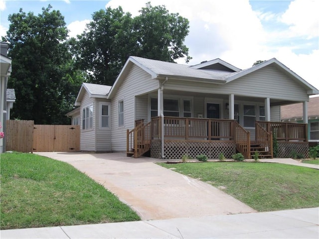 view of front of house with a front yard and covered porch