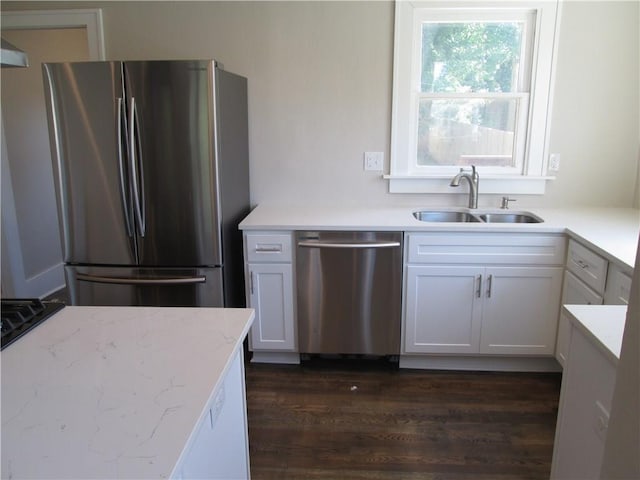 kitchen with white cabinetry, appliances with stainless steel finishes, sink, and dark hardwood / wood-style floors