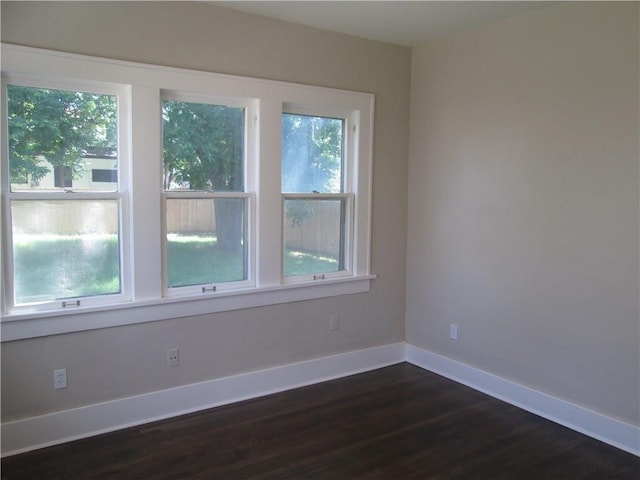 empty room with dark wood-type flooring