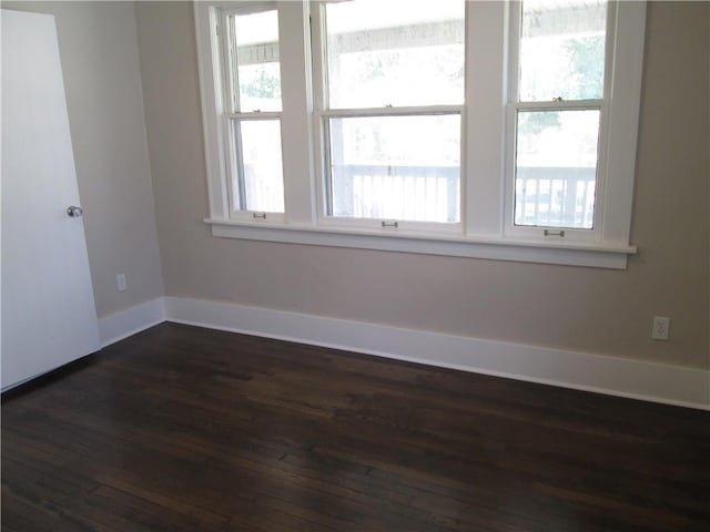 empty room with dark wood-type flooring