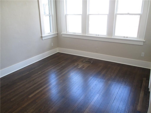 spare room with dark wood-type flooring