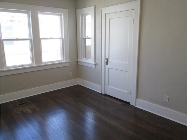 spare room featuring dark hardwood / wood-style floors