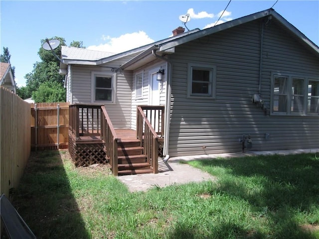 rear view of property with a lawn