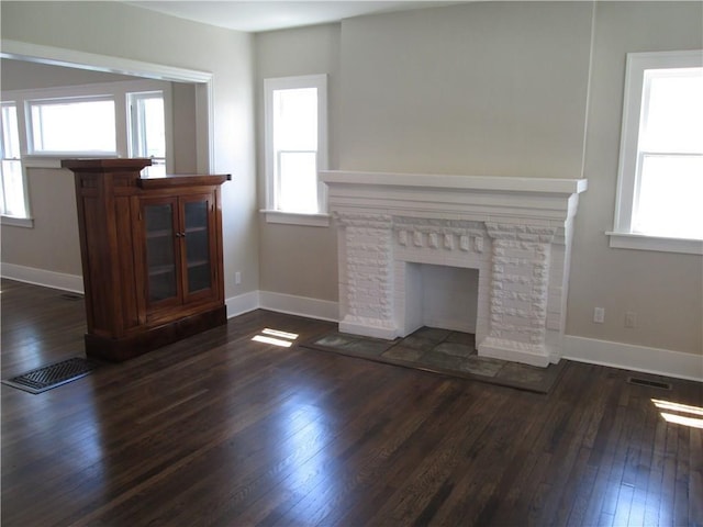 212 NE 15th St, Oklahoma City, OK 73104 - unfurnished living room featuring dark wood-type flooring and plenty of natural light