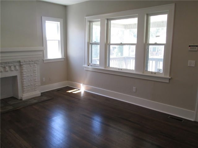 212 NE 15th St, Oklahoma City, OK 73104 - unfurnished living room with dark wood-style floors and baseboards
