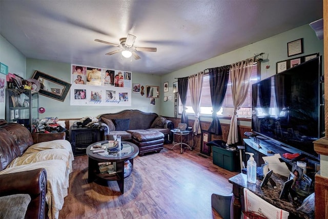 living room featuring hardwood / wood-style floors and ceiling fan