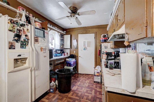 kitchen with dark parquet flooring, white fridge with ice dispenser, and ceiling fan