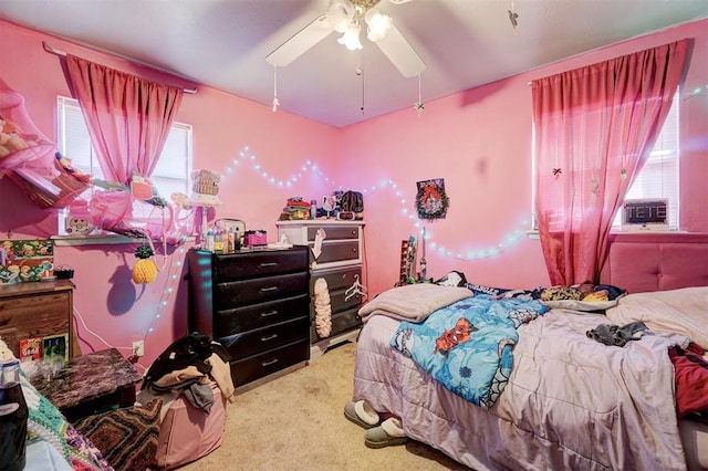 carpeted bedroom with ceiling fan and multiple windows