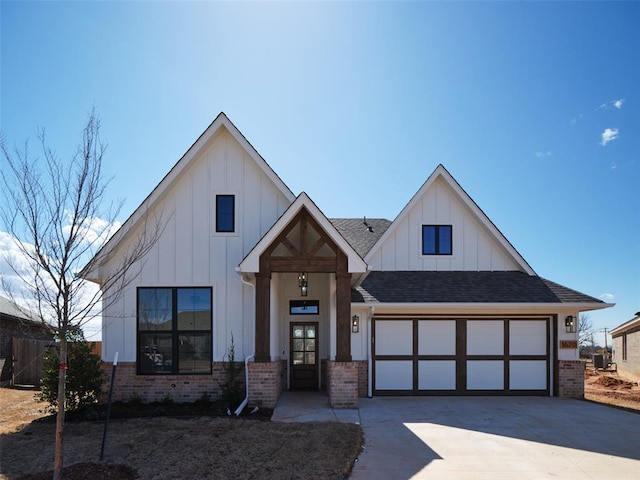 modern inspired farmhouse with a garage, driveway, brick siding, and board and batten siding