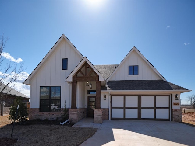 modern farmhouse style home featuring board and batten siding, concrete driveway, brick siding, and a garage