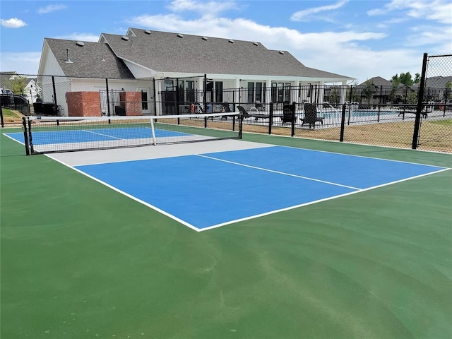 view of tennis court with fence