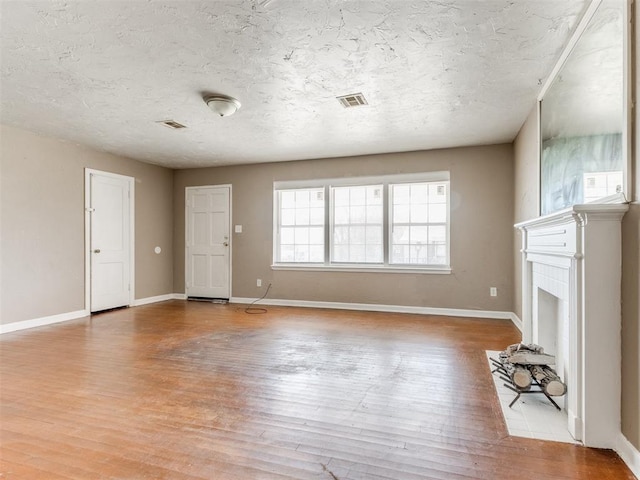 unfurnished living room with baseboards and light wood finished floors