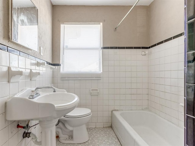 full bath with tile walls, toilet, and tile patterned floors