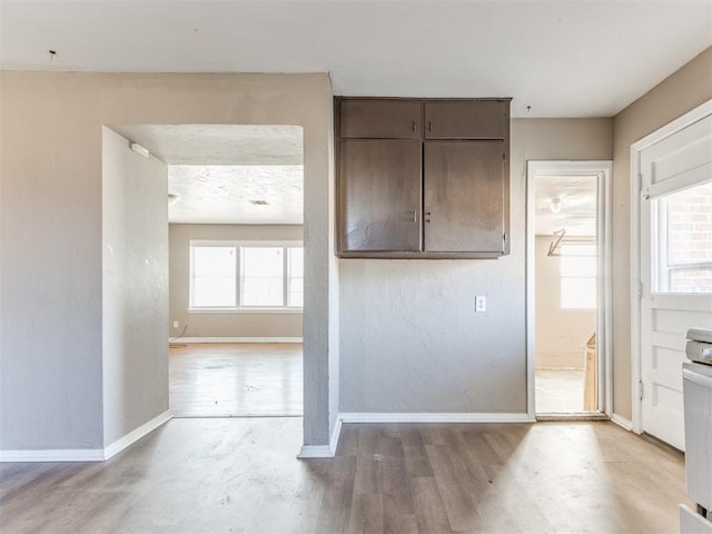 kitchen with baseboards and wood finished floors