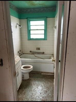 full bathroom with vanity, toilet, and tiled shower / bath combo