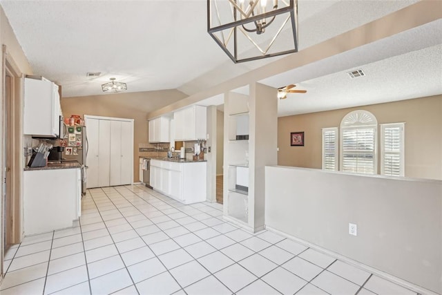 kitchen featuring white cabinetry, decorative backsplash, stainless steel dishwasher, light tile patterned floors, and ceiling fan