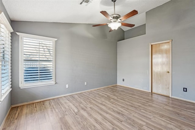 unfurnished room with ceiling fan, lofted ceiling, and light hardwood / wood-style floors