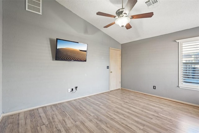 unfurnished room featuring vaulted ceiling, ceiling fan, and light hardwood / wood-style flooring