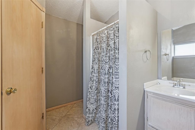 bathroom with vanity, tile patterned floors, and a textured ceiling