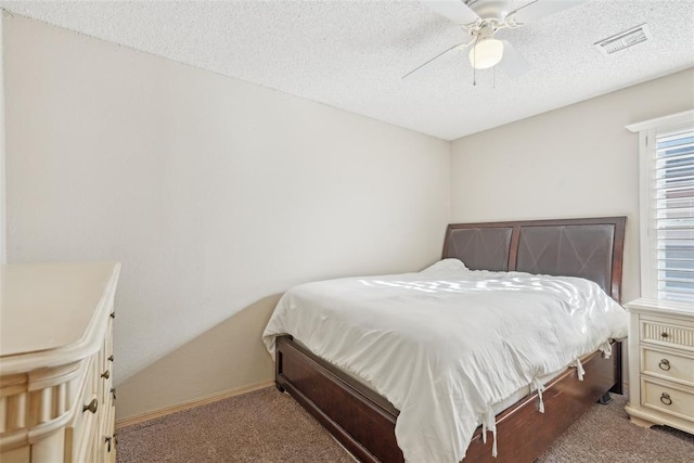 bedroom featuring a textured ceiling, ceiling fan, and carpet flooring