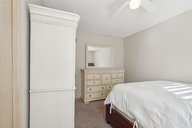 carpeted bedroom with a textured ceiling and ceiling fan