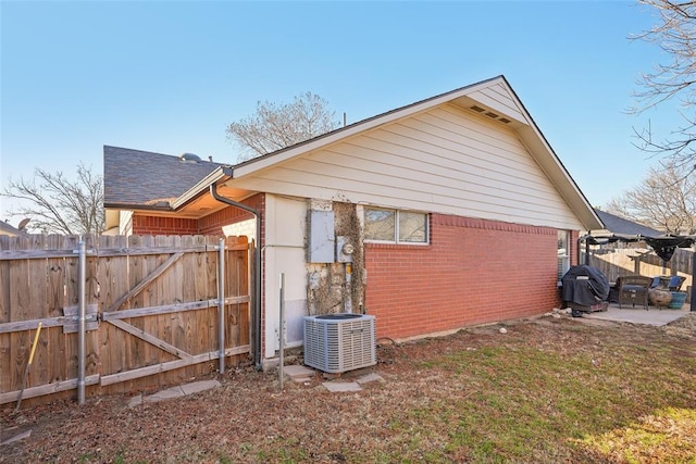 view of property exterior featuring cooling unit and a patio