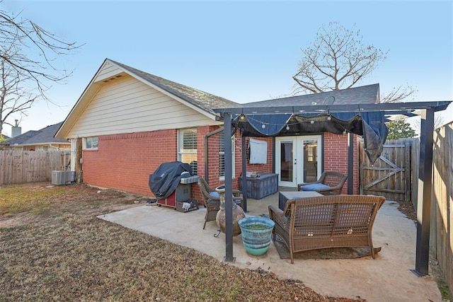 rear view of house featuring an outdoor hangout area, cooling unit, a patio area, and french doors