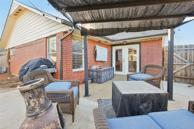 view of patio featuring french doors, area for grilling, and central air condition unit