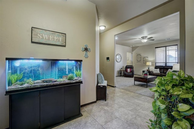 tiled living room featuring ceiling fan