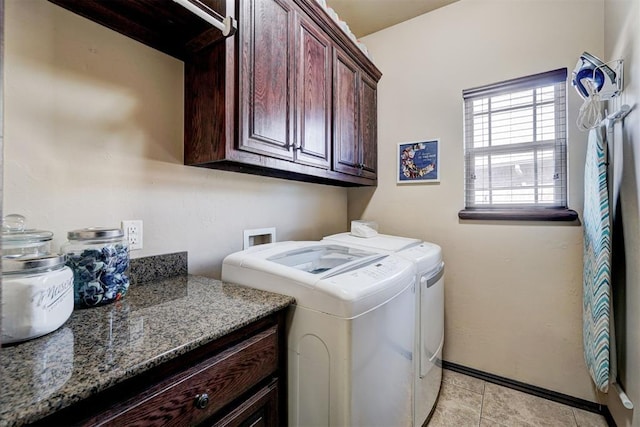 laundry area featuring cabinets, washer and dryer, and light tile patterned floors