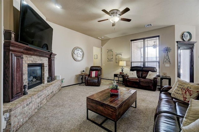 carpeted living room featuring a fireplace and ceiling fan