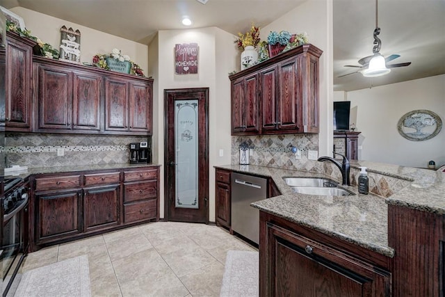 kitchen with stainless steel dishwasher, light stone countertops, sink, and black gas range