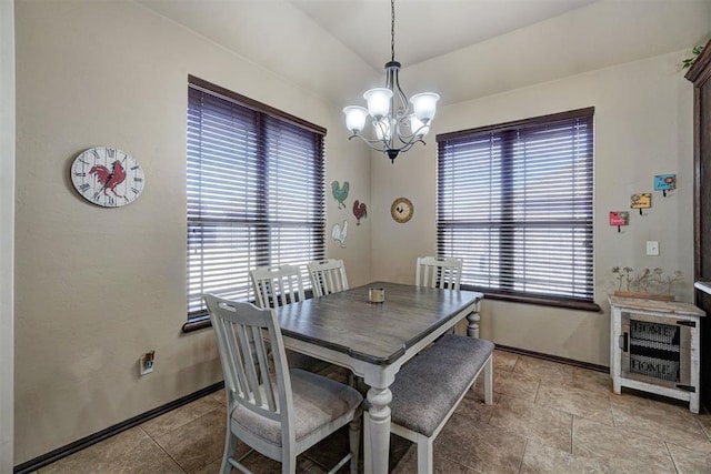 dining space featuring a chandelier, vaulted ceiling, heating unit, and a wealth of natural light