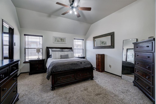 bedroom with ceiling fan, lofted ceiling, and light carpet