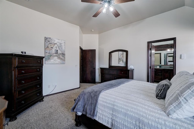 carpeted bedroom with ceiling fan, lofted ceiling, and connected bathroom