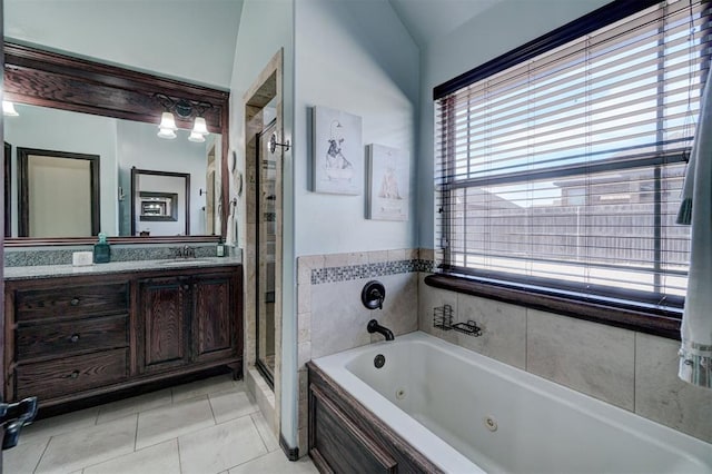 bathroom with independent shower and bath, vanity, and tile patterned floors