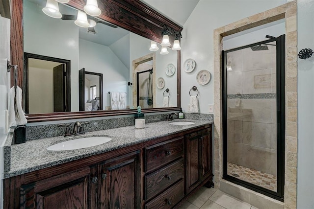 bathroom with vanity, a shower with shower door, tile patterned floors, and vaulted ceiling