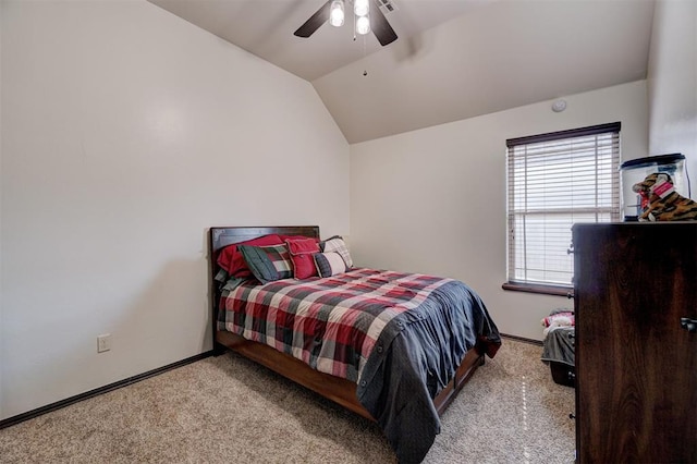 bedroom with ceiling fan, vaulted ceiling, and light carpet